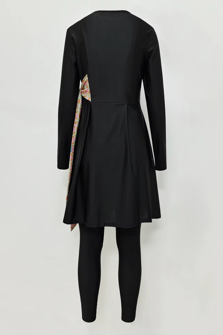 Black burkini with a colorful patterned lining on a white background