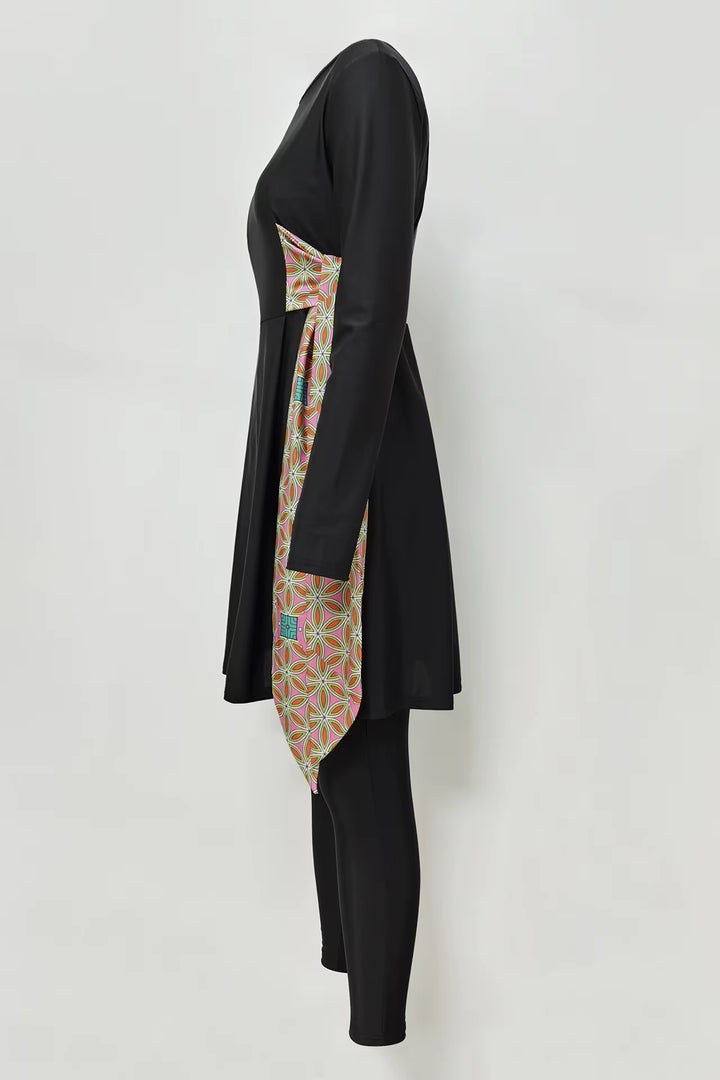 Black burkini with a colorful patterned tie on a white background