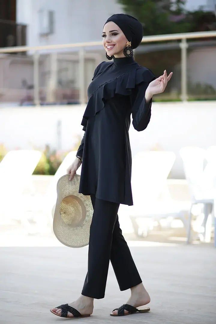 Close-up of ruffle detail from left shoulder to right hip on tunic top