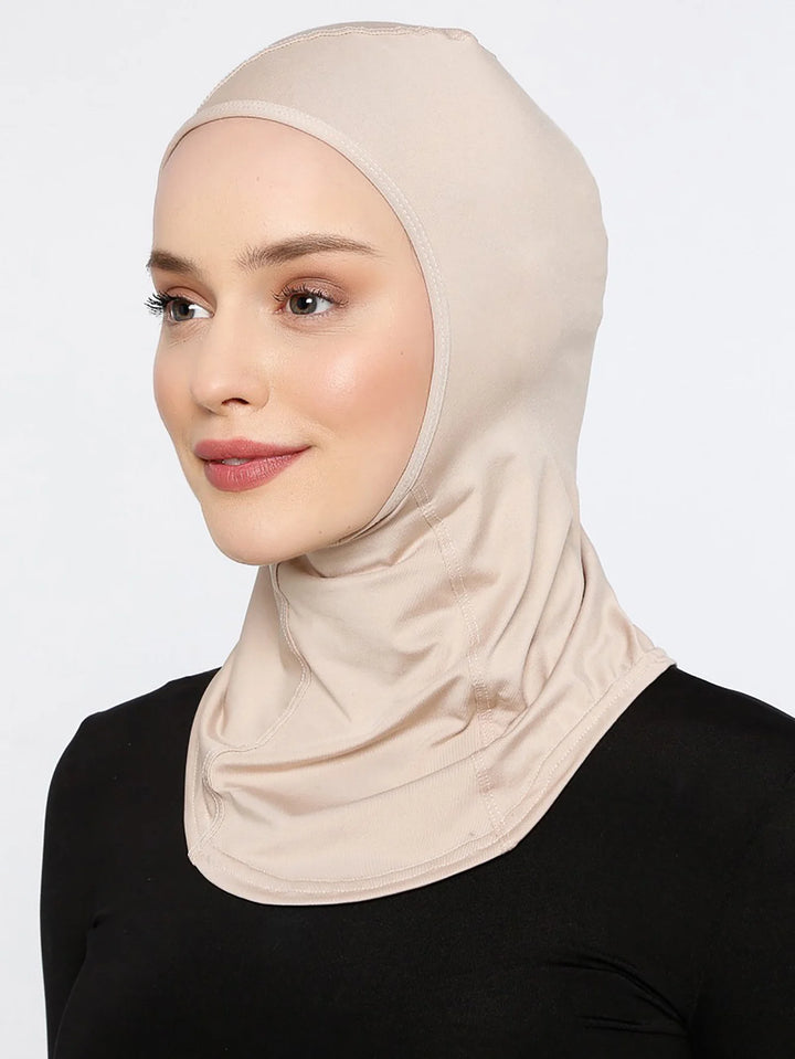 Folded cream hijab caps in multiple colors on neutral background