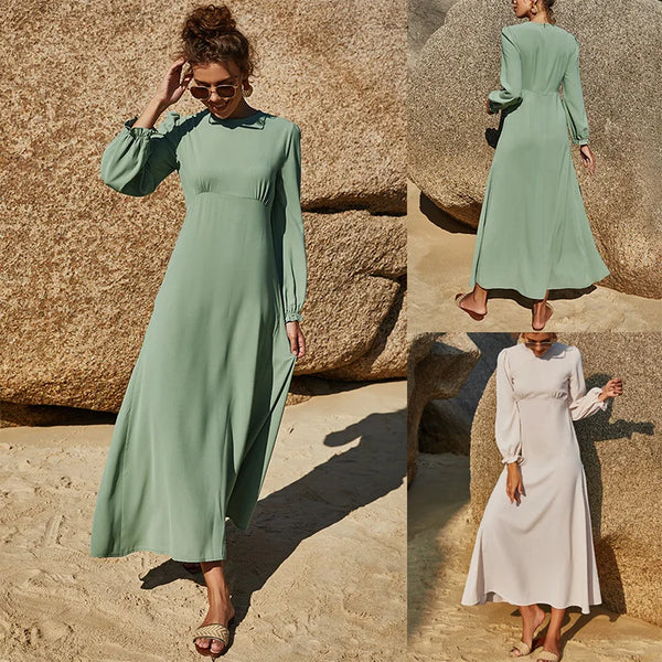 Front view of modest Islamic beach dress in sea green with long sleeves and flowy hem