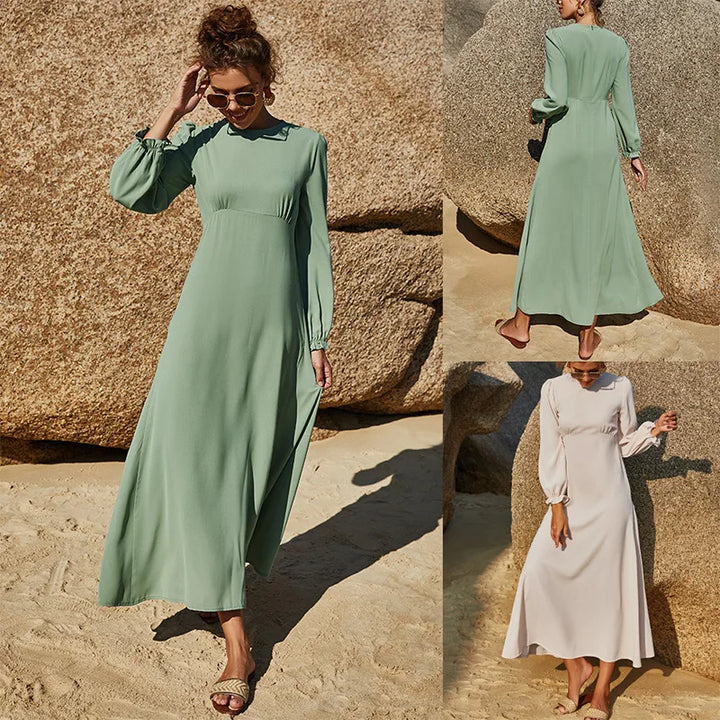 Front view of modest Islamic beach dress in sea green with long sleeves and flowy hem