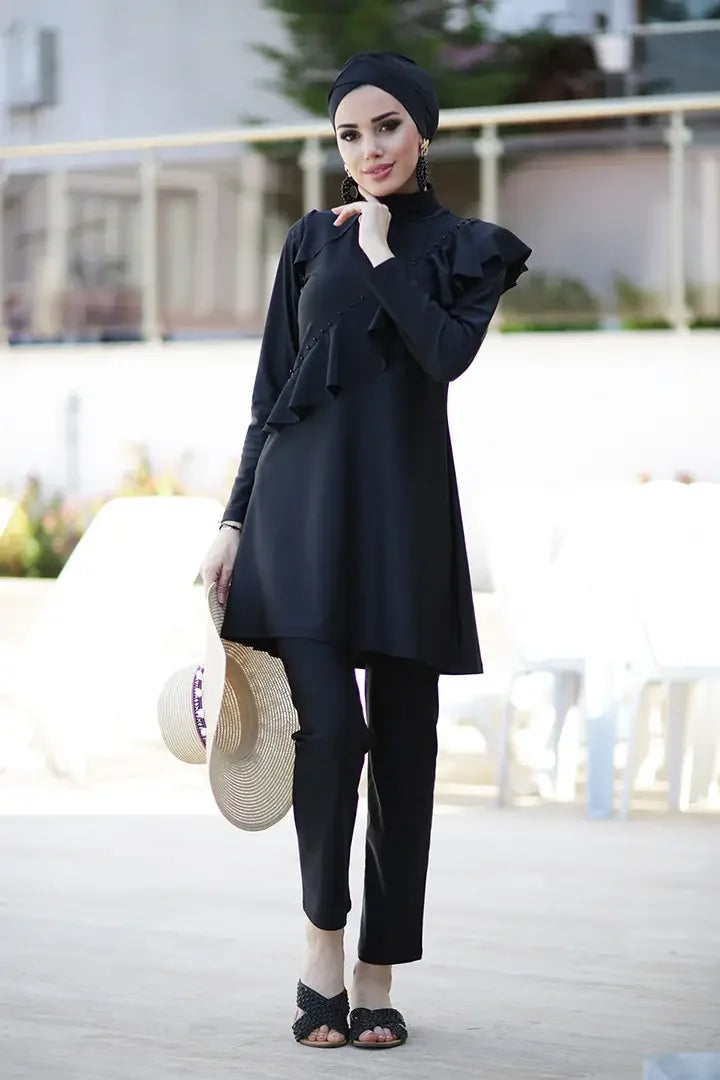 Front view of navy blue modest swimwear with shoulder-to-hip ruffle detail