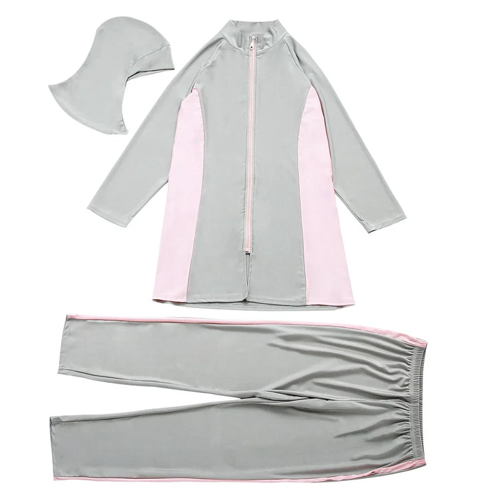 Gray and pink swimsuit set with matching cap on a white background