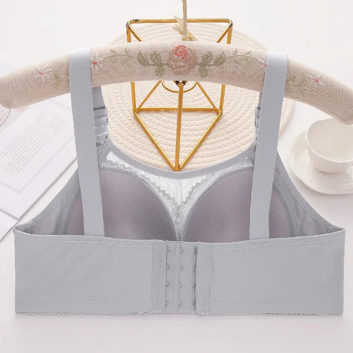 Gray bra on a hanger with a decorative background