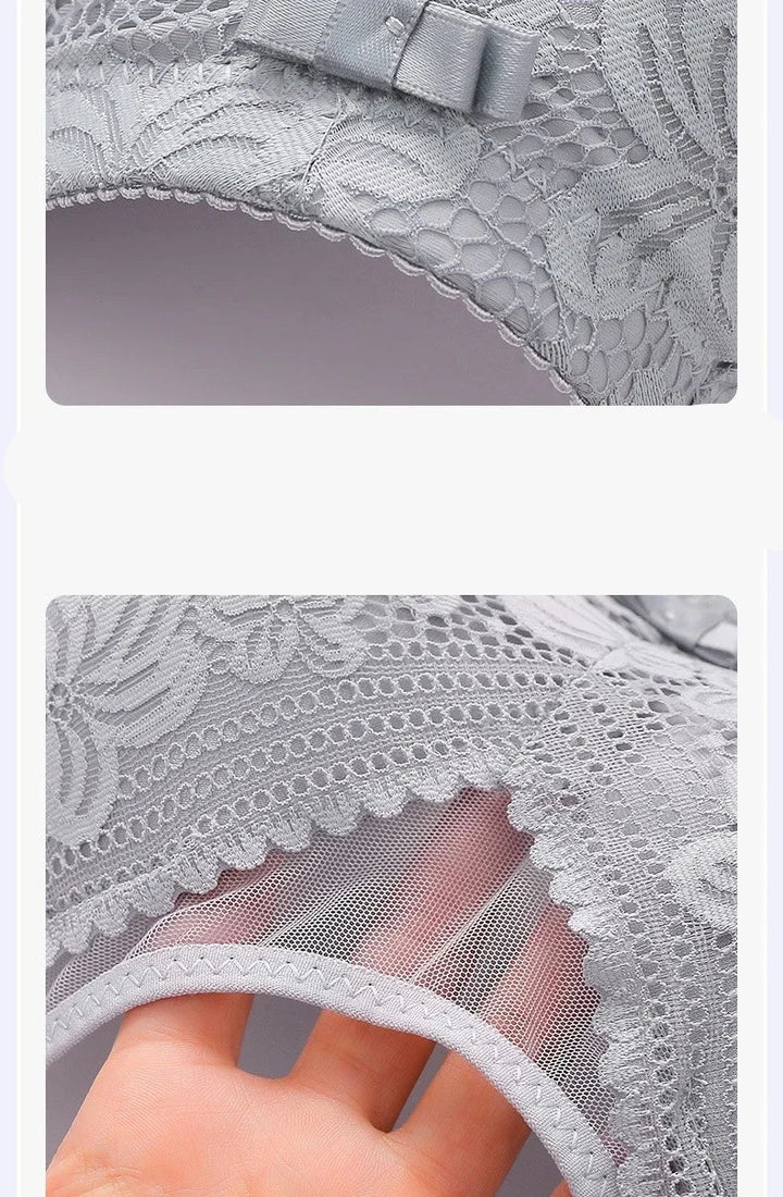 Gray lace fabric with embroidery decoration and a hand holding it to show texture.
