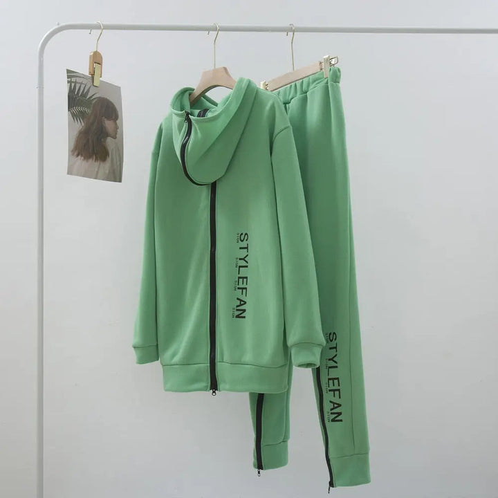 Green hoodie and pants set with '' branding on a white background