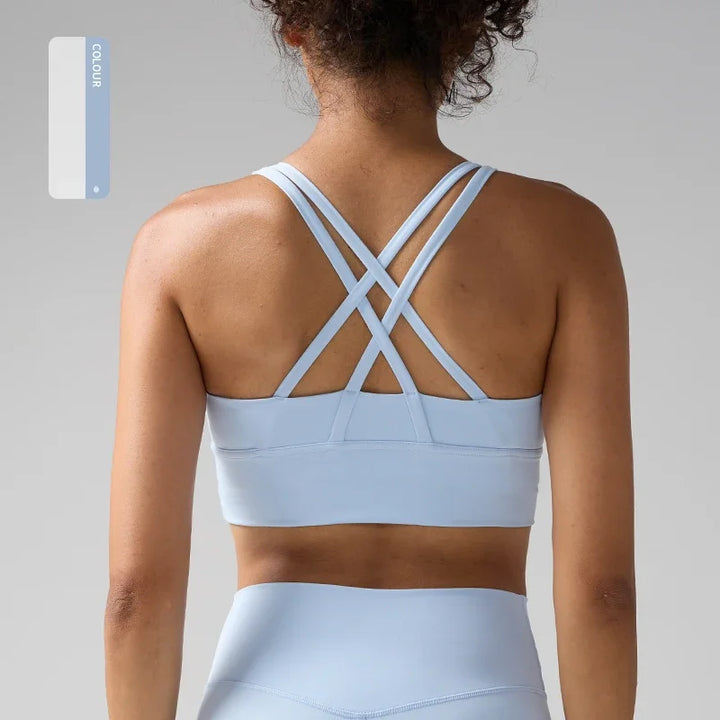 Light blue sports bra and leggings on a neutral background