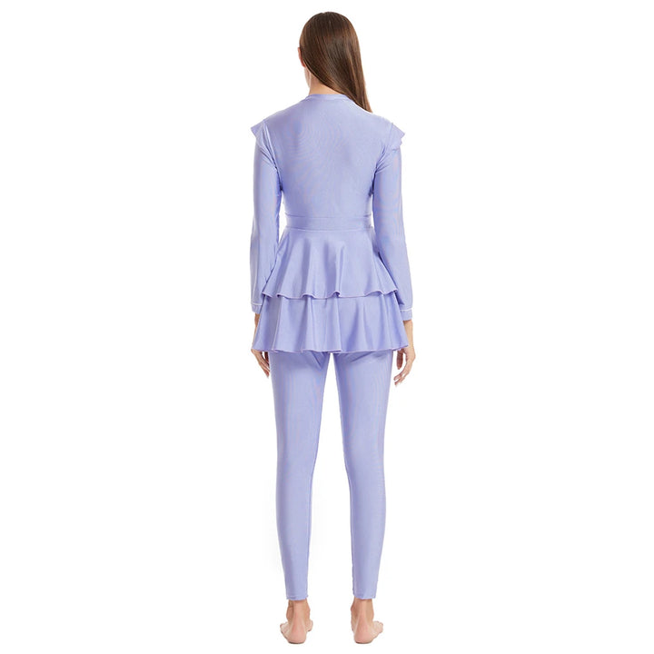 Model in full modest swimwear walking by pool in light purple outfit