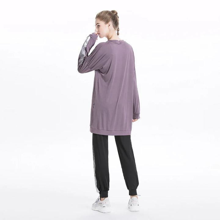 Model tying shoes while wearing gray modest athletic wear with side accents