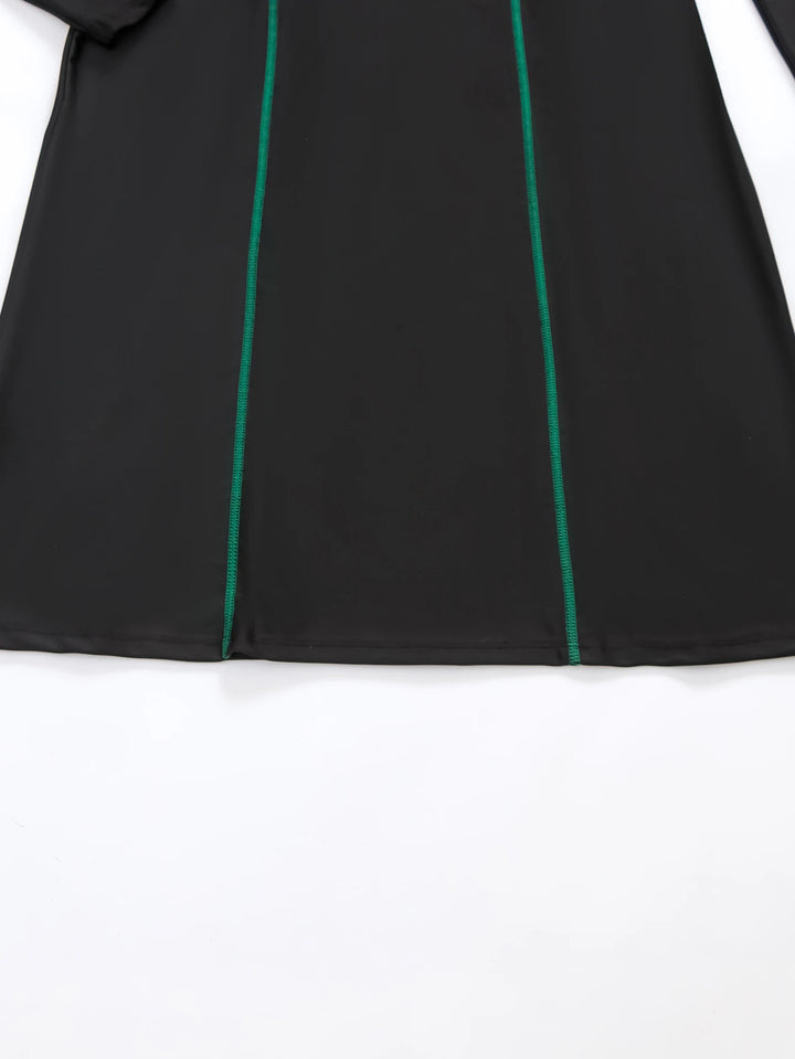 Model wearing full coverage Islamic swimsuit on beach with waves