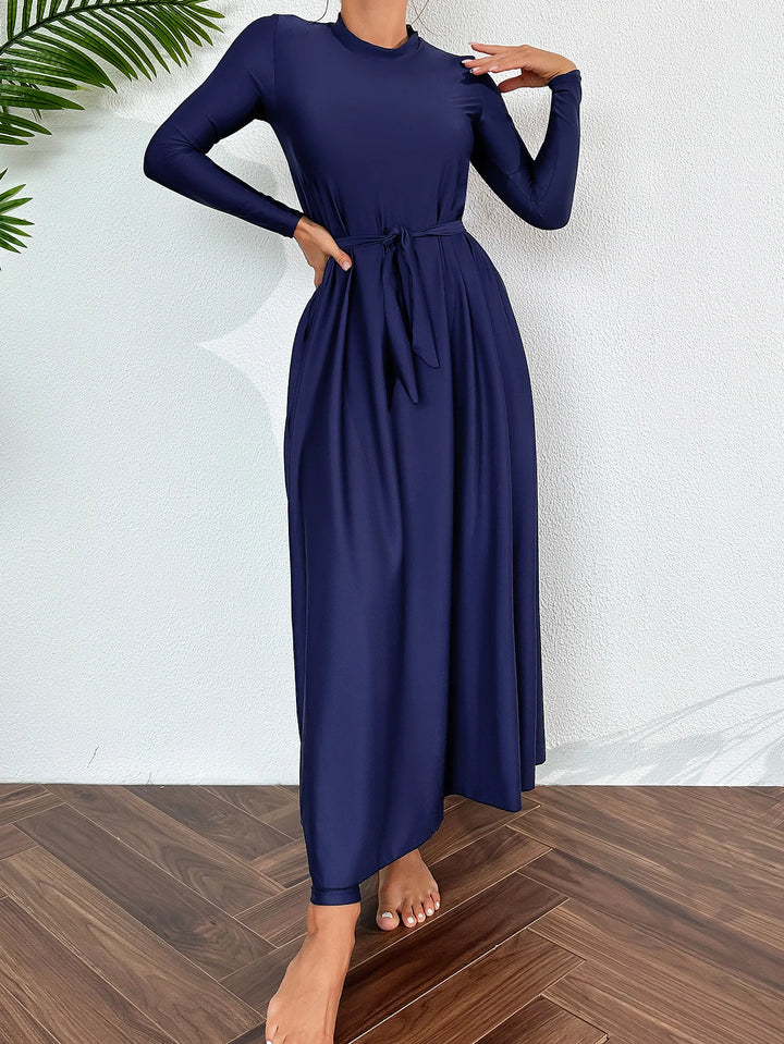 Muslim women’s full-coverage swimwear in navy blue with flowing maxi skirt