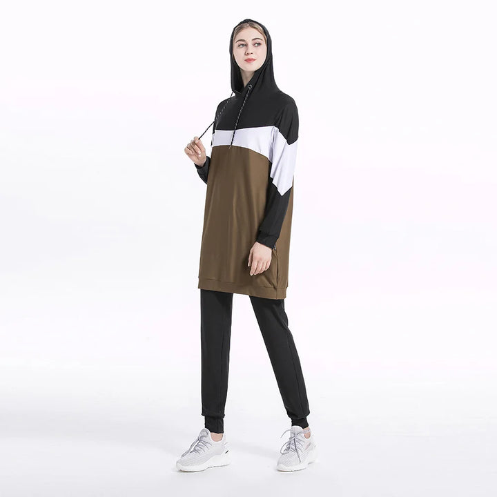 Person wearing a black, white, and brown color-modest activewear hoodie and pants 