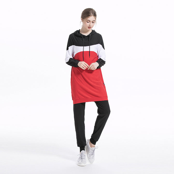 Person wearing a black, white, and red dress with a hood on a white background