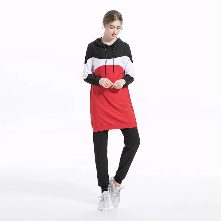 Person wearing a black, white, and red hoodie with matching pants on a white background