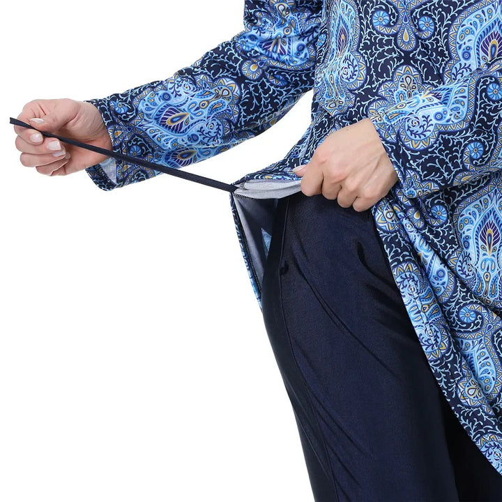 Person wearing a blue and white patterned shirt with a black belt for burkini