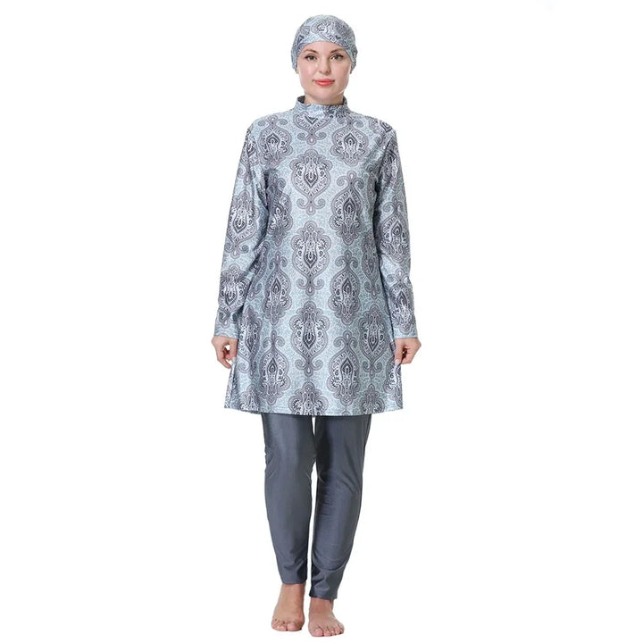 Person wearing a gray patterned burkini outfit with a matching headscarf on a white background