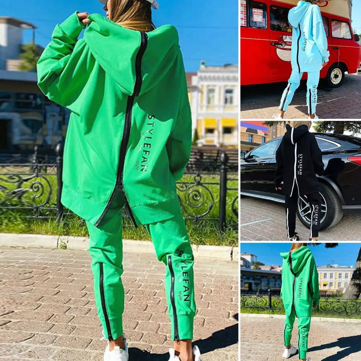 Person wearing a green tracksuit with '' branding in an urban setting.