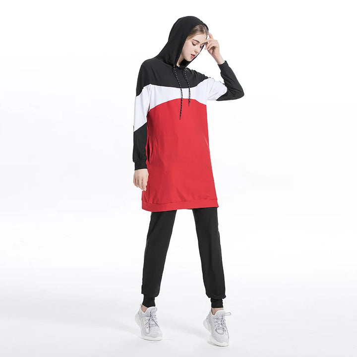 Person wearing a red, black, and white hoodie with matching pants on a white background
