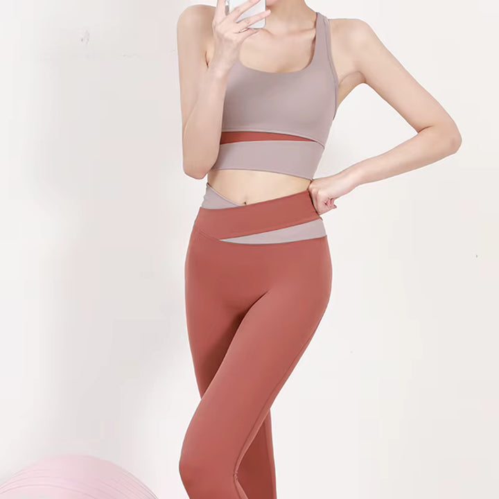 Person wearing a sports bra and leggings on a plain background