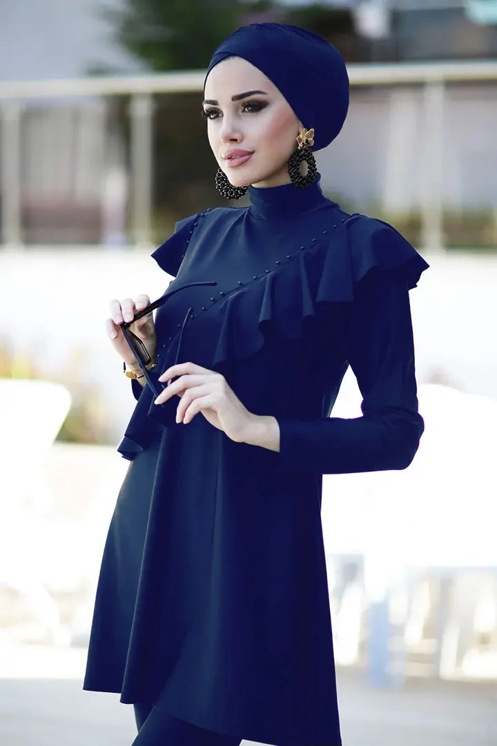 Model adjusting swim cap with coordinated modest bathing suit in black