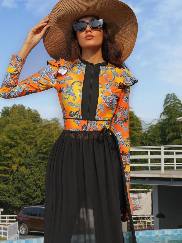 Detail shot of lightweight polyester fabric with paisley print in orange and yellow