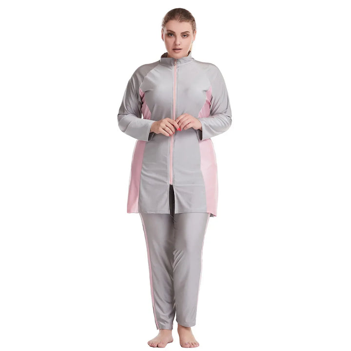 Woman wearing a gray and pink plus burkini swimsuit on a white background