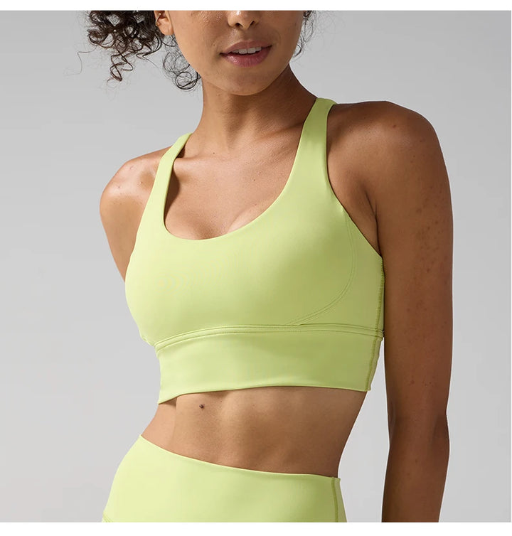 Woman wearing a light green sports bra and leggings