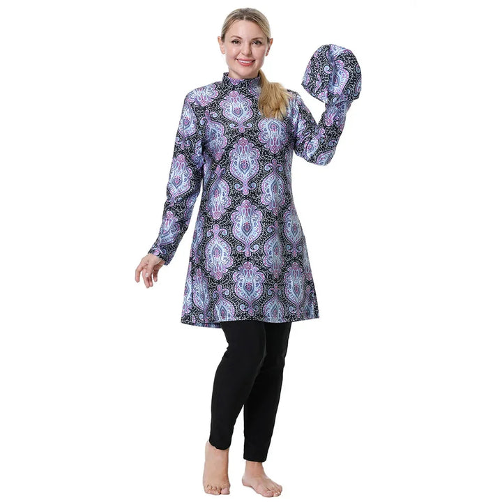 Woman wearing a long-sleeve patterned top and black leggings on a white background