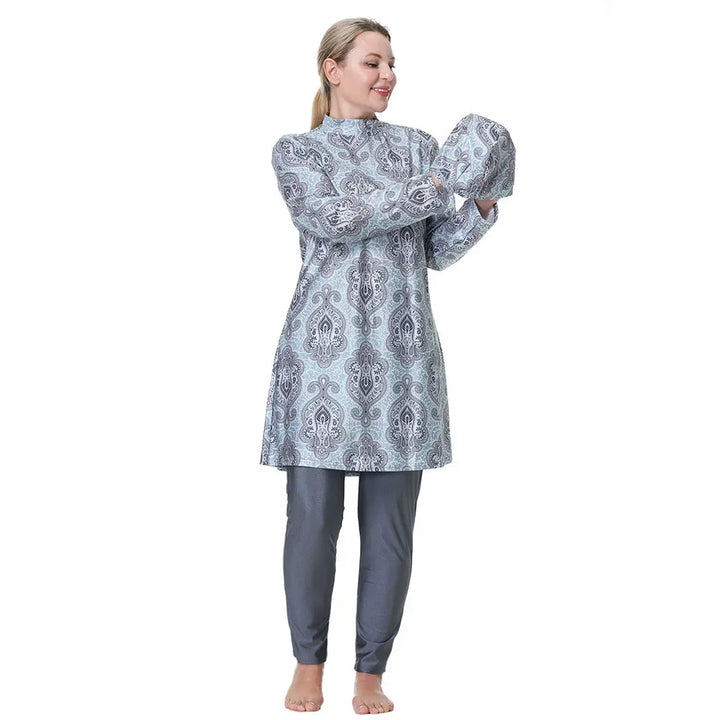 Woman wearing a patterned burkini set on a white background