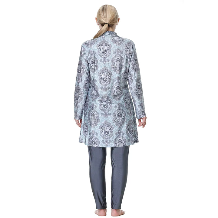 Woman wearing a patterned burkini top and pants on a white background