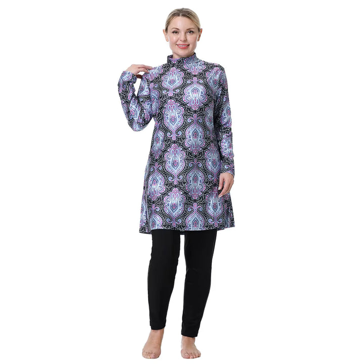 Woman wearing a patterned long-sleeve top and black leggings on a white background