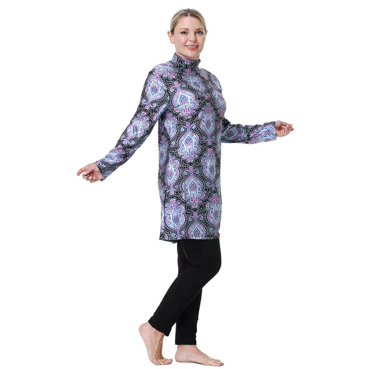 Woman wearing a patterned long-sleeve top and black pants