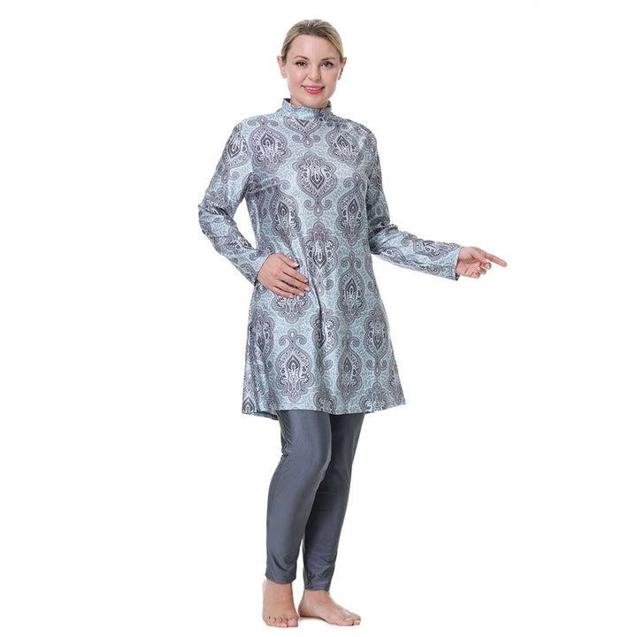 Woman wearing a patterned long-sleeve top and pants on a white background