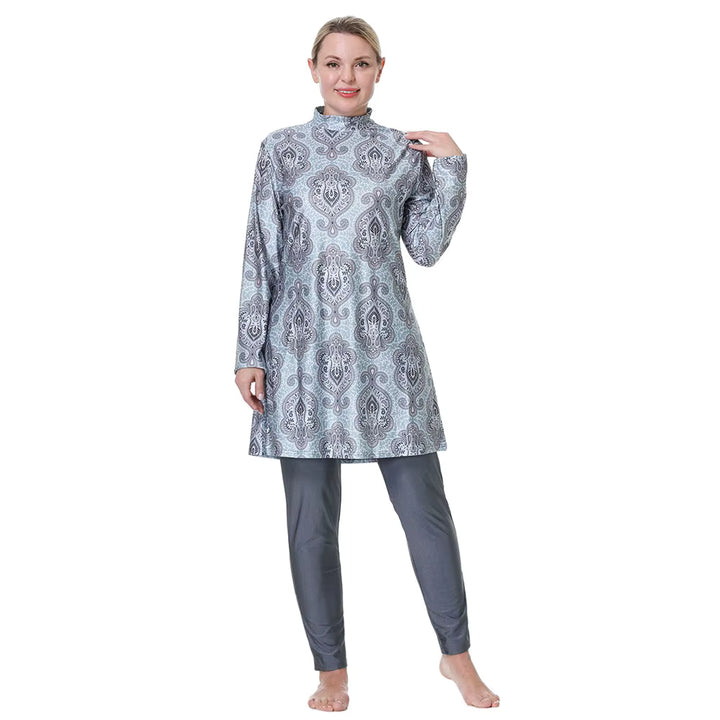 Woman wearing a patterned long-sleeve top and pants on a white background