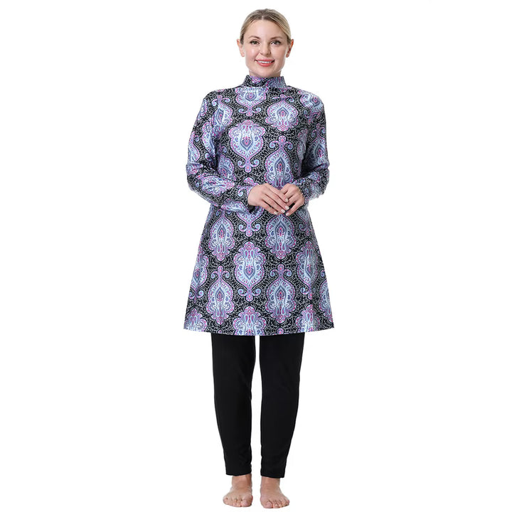 Woman wearing a patterned top and long swim black pants 